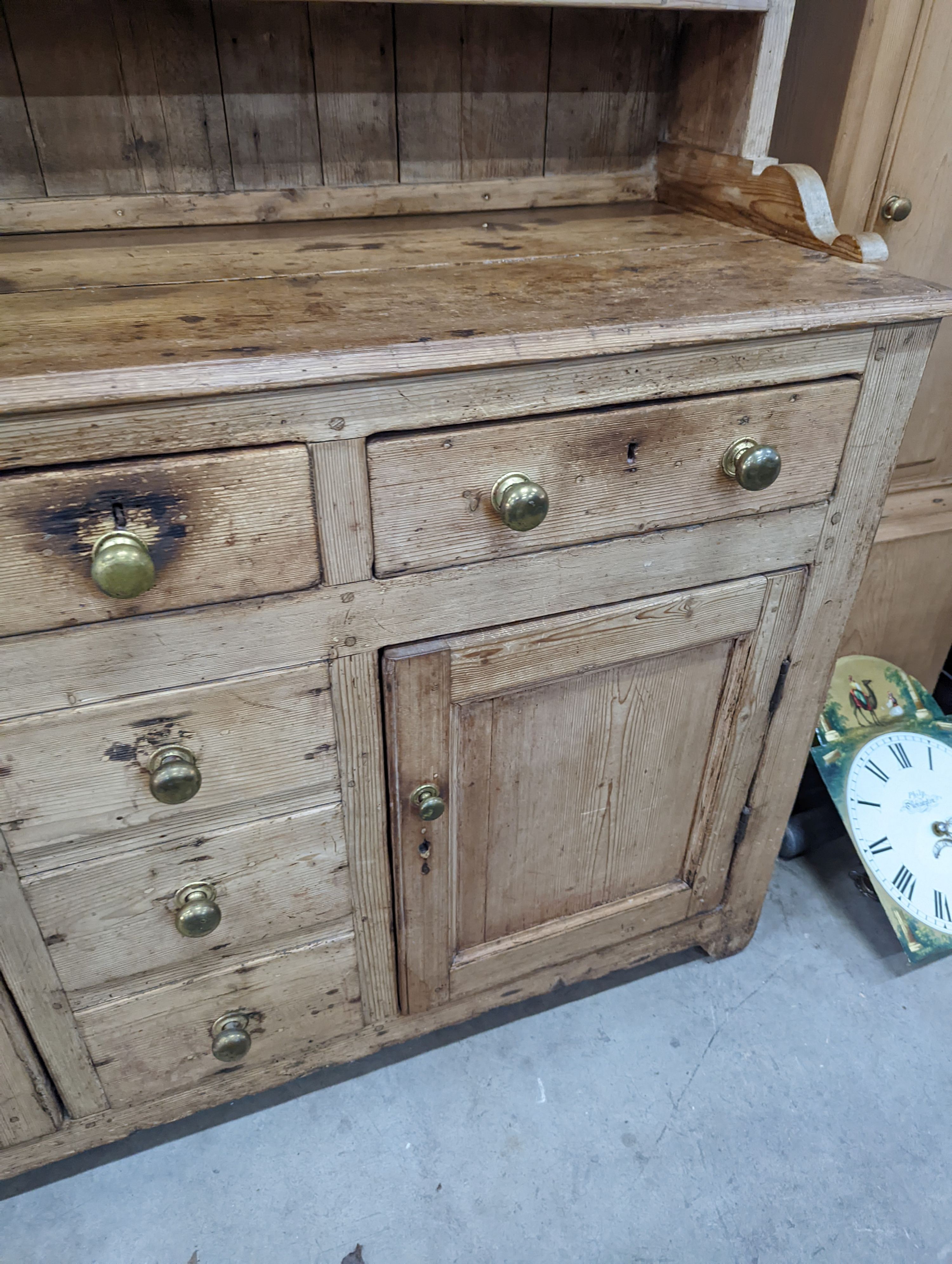 An early 19th century pine dresser with boarded rack, width 141cm, depth 49cm, height 206cm